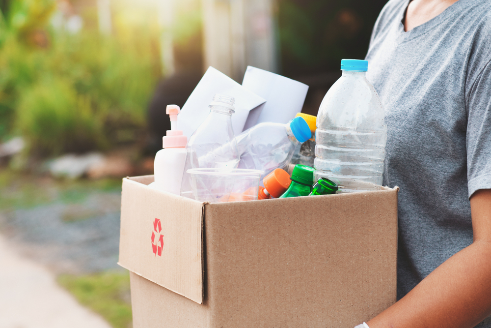 Woman carrying garbage for disposal